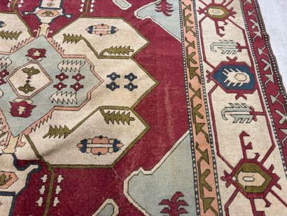 Large hand-knotted wool rug with stylized...