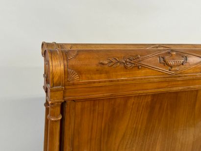 Carved wood bed decorated with basins and...