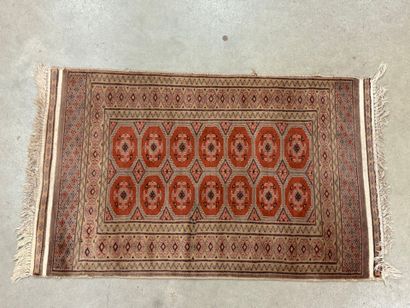 Hand-knotted wool rug with stylized motifs.
95...