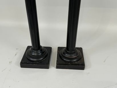 Two blackened wood saddles, fluted shaft,...