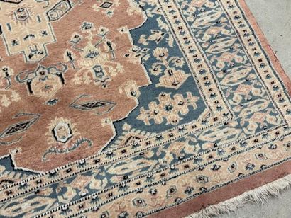 Hand-knotted wool rug with stylized motifs.
184...