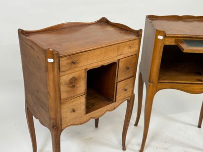 Two wooden bedside tables, one opening with...