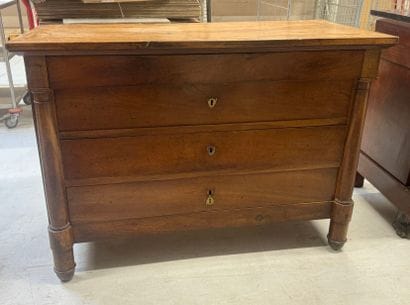 Natural wood chest of drawers with half detached...