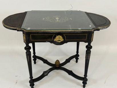 Middle table in blackened wood, opening with...
