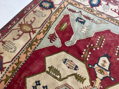 Large hand-knotted wool rug with stylized...