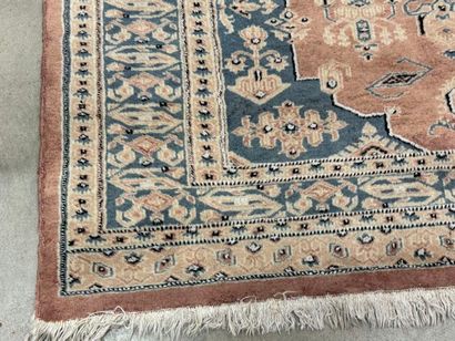 Hand-knotted wool rug with stylized motifs.
184...