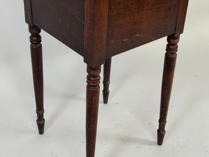 Turned wood bedside table opening with a...