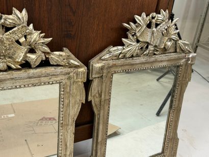 Pair of carved wood and silver-plated mirrors...