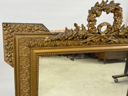 Wood and gilded stucco mirror decorated with...