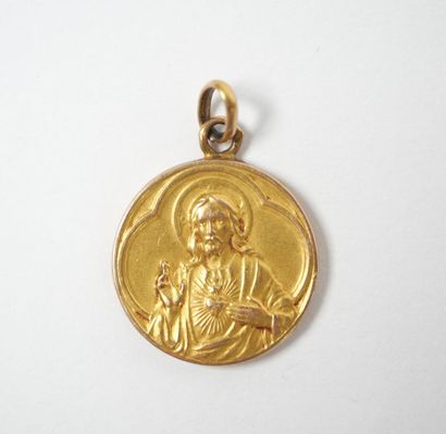 Circular religious medal in 18K yellow gold...