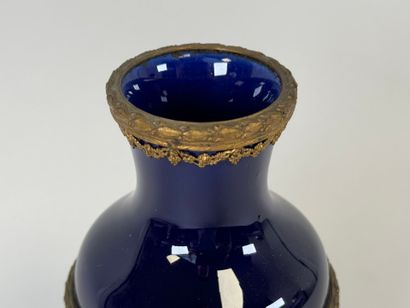Vase en céramique sur fond bleu, la monture...