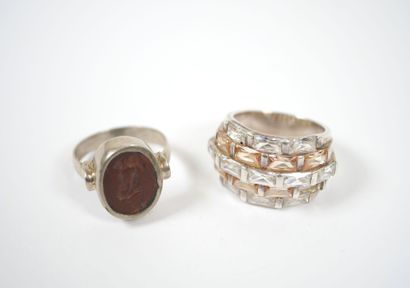 Two metal rings, one with five rows of white...