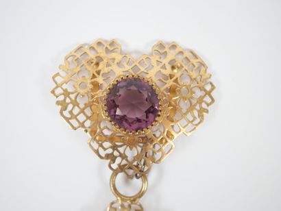 Set in openwork gilt metal adorned with crimped...