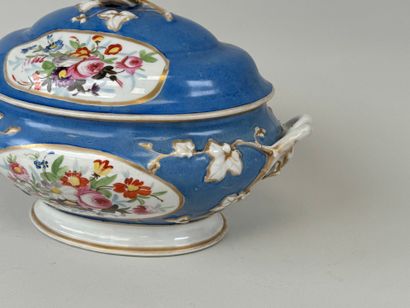 A large polychrome porcelain tureen decorated...