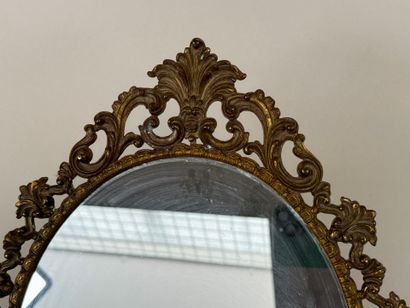 Oval brass mirror decorated with foliage...