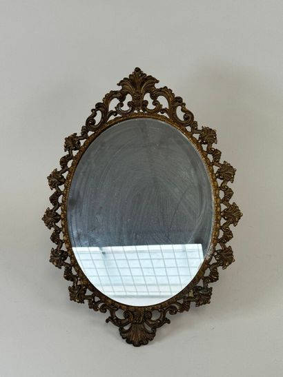 Oval brass mirror decorated with foliage...