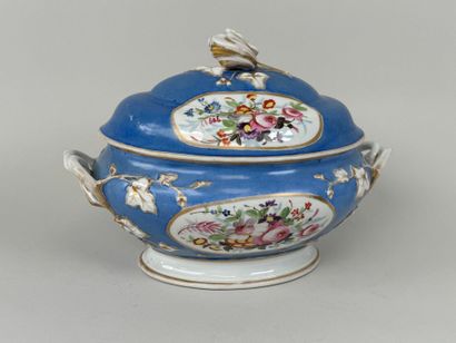 A large polychrome porcelain tureen decorated...