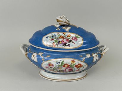 A large polychrome porcelain tureen decorated...