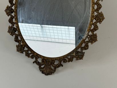 Oval brass mirror decorated with foliage...