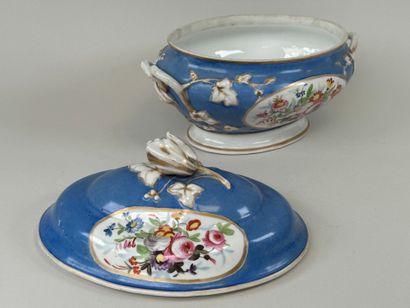 A large polychrome porcelain tureen decorated...