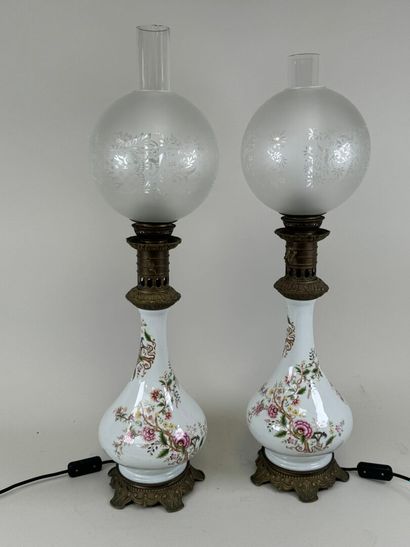 Pair of polychrome porcelain oil lamps, chased...
