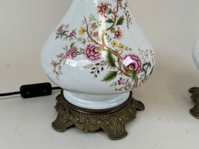 Pair of polychrome porcelain oil lamps, chased...