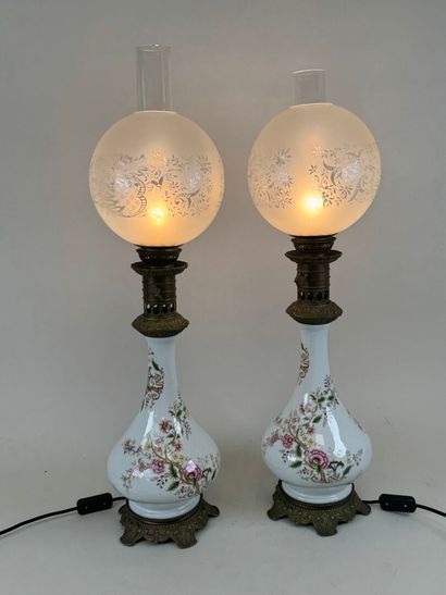 Pair of polychrome porcelain oil lamps, chased...