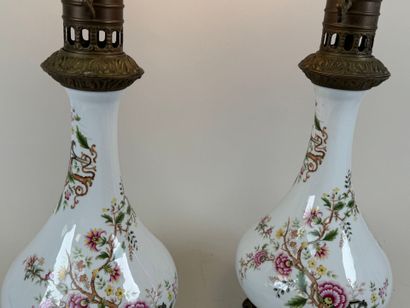 Pair of polychrome porcelain oil lamps, chased...