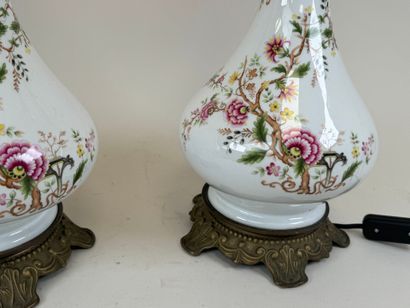 Pair of polychrome porcelain oil lamps, chased...