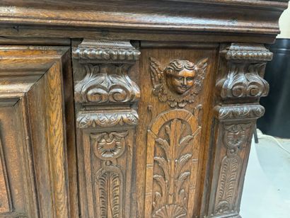 Large molded and carved oak desk decorated...