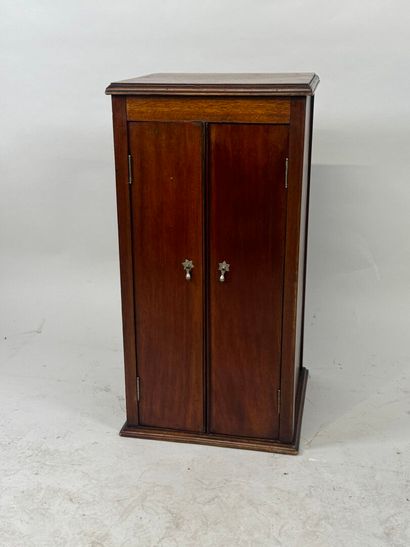 Mahogany cabinet opening with two doors,...