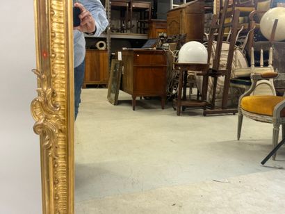 Large gilded and carved wood mirror with...