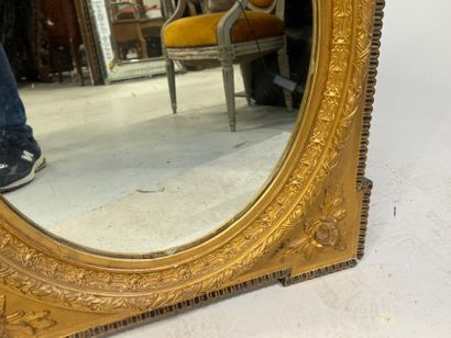 Wood and gilded stucco mirror with oval view,...