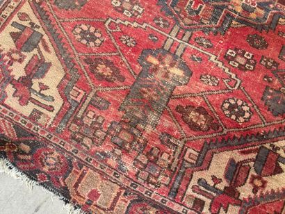 Hand-knotted wool rug with geometric motifs.
200...
