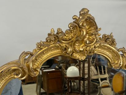 Large gilded and carved wood mirror with...