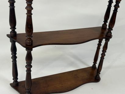 Small four-tier wall shelf in turned wood.
78...