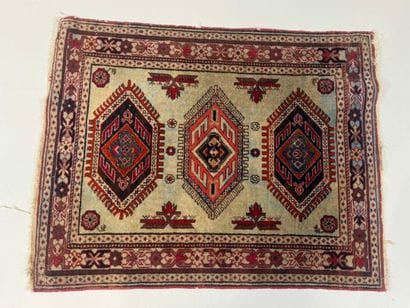Small hand-knotted wool rug with stylized...