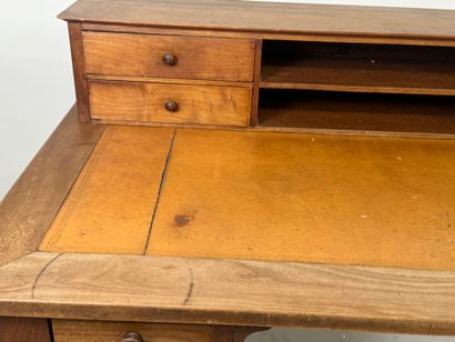 Tiered desk in molded wood opening with three...