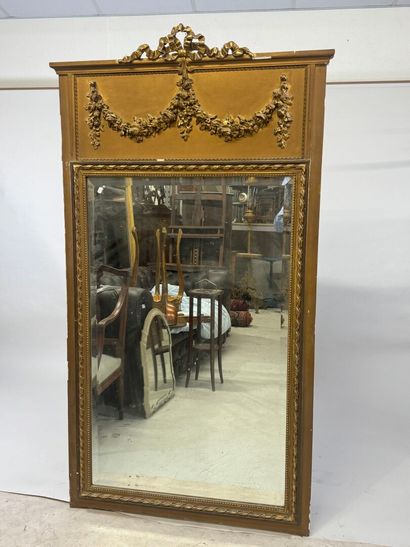 Large mirror in wood and gilded stucco, the...