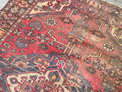 Hand-knotted wool rug with geometric motifs.
200...