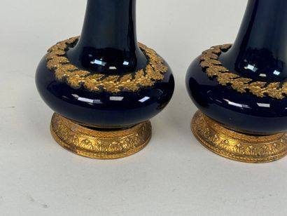 A pair of blue earthenware vases, with chased...