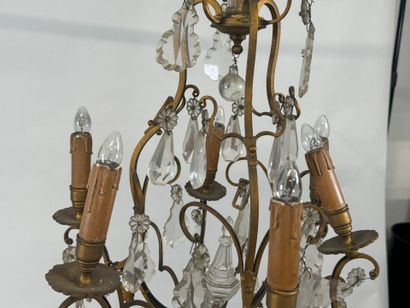 Six-arm bronze chandelier with crystal pendants.
H....