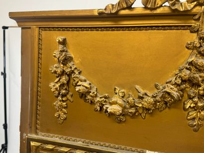 Large mirror in wood and gilded stucco, the...