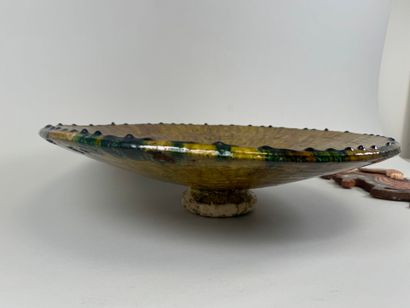 Large circular dish on heel in glazed ceramic...