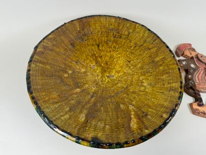 Large circular dish on heel in glazed ceramic...