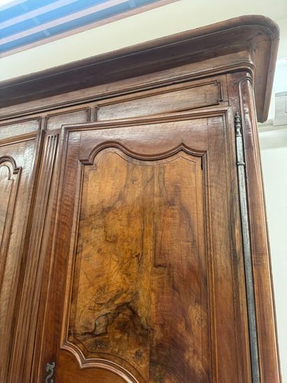 Large walnut armoire opening with two molded...