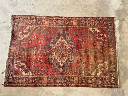 Hand-knotted wool rug with geometric motifs.
200...