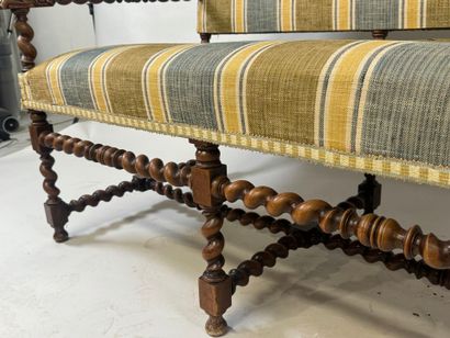 Molded and twisted wood bench, the arms decorated...