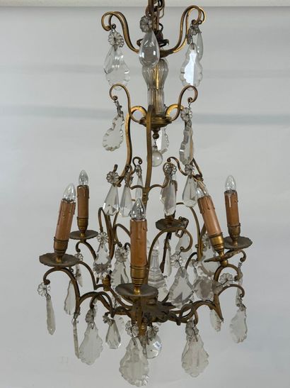 Six-arm bronze chandelier with crystal pendants.
H....