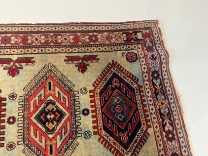 Small hand-knotted wool rug with stylized...